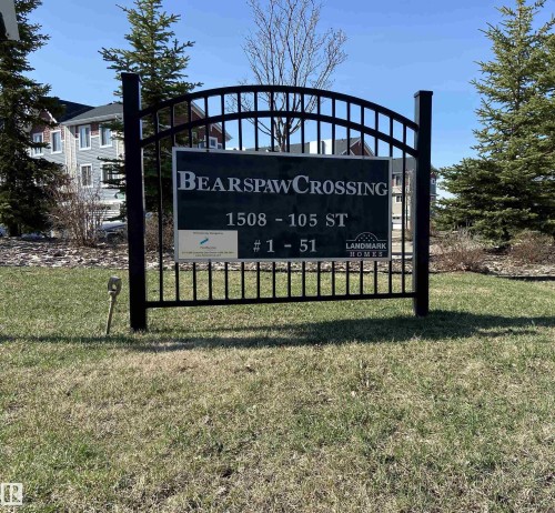 Community signage featuring wrought iron detailing, a dark green information panel, and white lettering - 1520 105 Street, Edmonton, AB - Outdoor