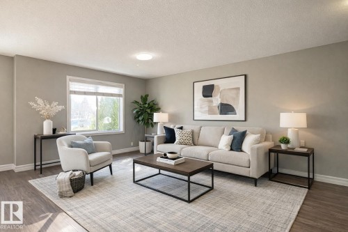 Spacious living area featuring wood-finish flooring, neutral wall tones, and a large window with privacy blinds - 1520 105 Street, Edmonton, AB - Indoor Photo Showing Living Room