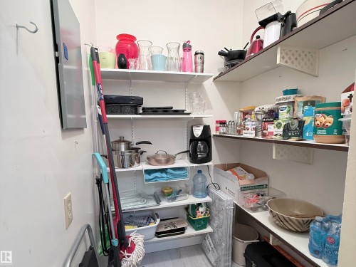 Recessed pantry space featuring white wall-mounted shelving, offering ample storage - 2071 Saddleback Road, Edmonton, AB - Indoor With Storage
