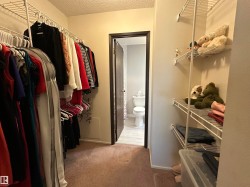 Walk-in closet featuring wire shelving and hanging rods - 