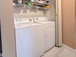 Dedicated laundry area featuring wire shelving, a washer, and a dryer - 