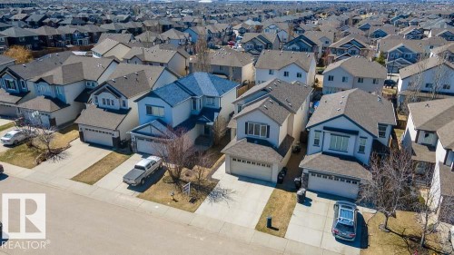 Residential street featuring multiple properties with attached garages - 1734 63A Street, Edmonton, AB - Outdoor