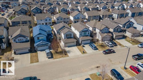 Contemporary residential neighborhood featuring detached homes with asphalt shingle roofs - 1734 63A Street, Edmonton, AB - Outdoor