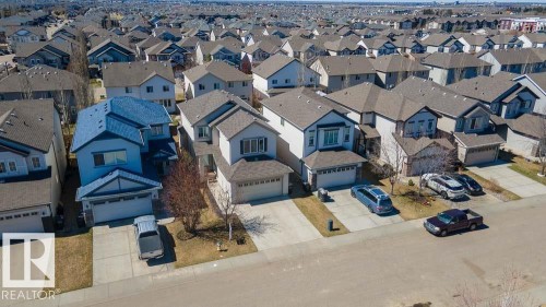 Contemporary suburban architecture featuring multiple gabled roofs, attached two-car garages, and paved driveways - 1734 63A Street, Edmonton, AB - Outdoor With Facade
