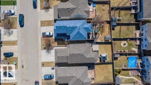 Aerial perspective of a residential street featuring uniform sidewalks and multiple detached homes - 1734 63A Street, Edmonton, AB - Outdoor