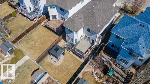 Private backyard featuring a screened-in deck, a detached storage shed, a gazebo with a stone-lined base, and wood fencing - 1734 63A Street, Edmonton, AB - Outdoor