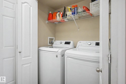 Dedicated laundry area featuring a top-load washing machine and front-load dryer - 7723 7A Avenue, Edmonton, AB - Indoor Photo Showing Laundry Room