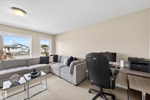 Bright interior space with multiple windows and neutral wall tones - 7723 7A Avenue, Edmonton, AB - Indoor Photo Showing Living Room