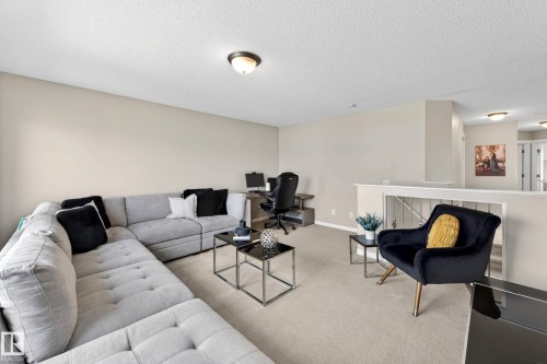 Open concept upper level featuring neutral wall tones and carpeted flooring - 7723 7A Avenue, Edmonton, AB - Indoor Photo Showing Living Room