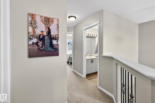 Upper-level hallway featuring neutral wall paint, carpet flooring, and a flush-mount ceiling light - 7723 7A Avenue, Edmonton, AB - Indoor Photo Showing Other Room