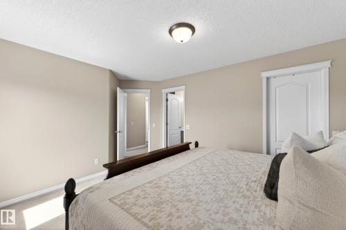 Bedroom featuring light neutral wall paint, white trim, recessed light fixture, and carpet flooring - 7723 7A Avenue, Edmonton, AB - Indoor Photo Showing Bedroom