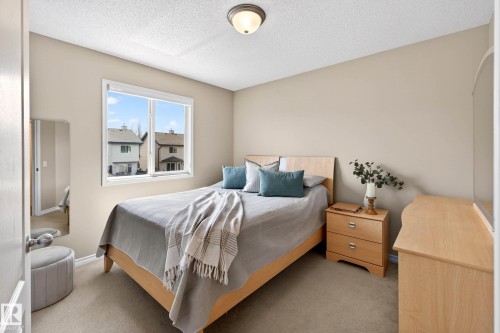 Bedroom featuring light tan walls and a single window with a white frame - 7723 7A Avenue, Edmonton, AB - Indoor Photo Showing Bedroom