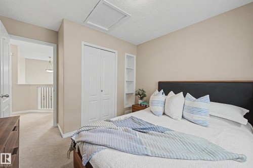 Inviting room featuring a neutral color palette, soft carpet flooring, and a double bi-fold closet - 7723 7A Avenue, Edmonton, AB - Indoor Photo Showing Bedroom