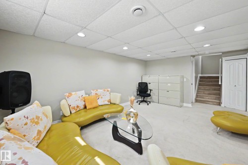 Carpeted room with drop ceiling featuring recessed lighting - 7723 7A Avenue, Edmonton, AB - Indoor