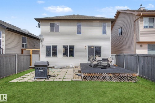 Spacious backyard featuring a multi-level deck, a concrete patio, and a manicured lawn - 7723 7A Avenue, Edmonton, AB - Outdoor With Deck Patio Veranda With Exterior
