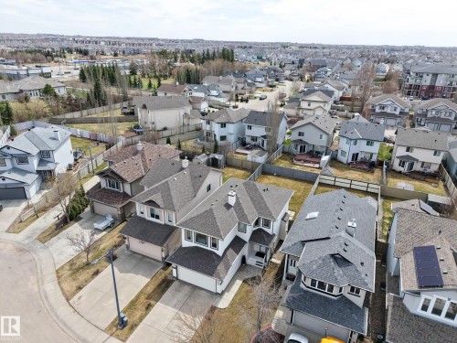 Suburban residential architecture featuring multiple detached homes with asphalt shingle roofs - 7723 7A Avenue, Edmonton, AB - Outdoor With View