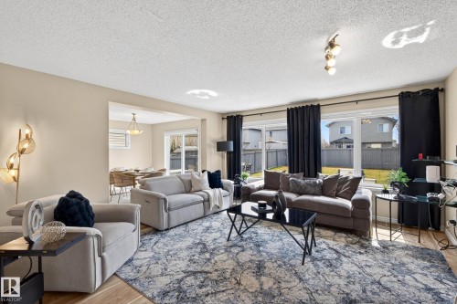Open-concept living area with wood-finish flooring - 7723 7A Avenue, Edmonton, AB - Indoor Photo Showing Living Room