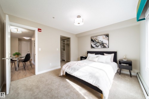 Carpeted sleeping area featuring neutral wall tones and a window with natural light - 117 2229 44 Avenue, Edmonton, AB - Indoor Photo Showing Bedroom