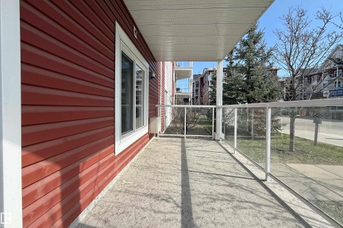 Spacious private balcony featuring a concrete floor, glass panel railing, and white trim - 117 2229 44 Avenue, Edmonton, AB - Outdoor With Balcony With Exterior