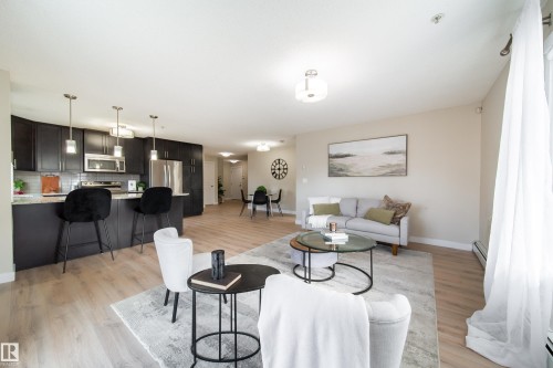 Open-concept living area with light wood-finish flooring - 117 2229 44 Avenue, Edmonton, AB - Indoor Photo Showing Living Room