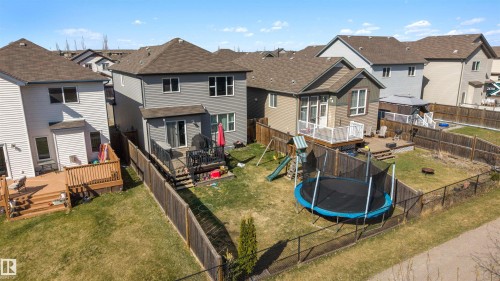 Expansive backyard featuring a manicured lawn, a chain-link fence, and a wooden privacy fence - 6115 18 Avenue, Edmonton, AB - Outdoor