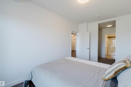 Interior room featuring neutral wall finishes and carpet flooring - 205 1316 Windermere Way, Edmonton, AB - Indoor Photo Showing Bedroom