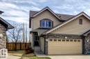 Two-story residence featuring light brown siding and stone veneer accents - 119 Rue Monique, Beaumont, AB  - Outdoor 