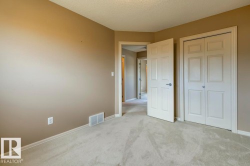 Neutral-toned interior with light carpet flooring - 119 Rue Monique, Beaumont, AB - Indoor Photo Showing Other Room