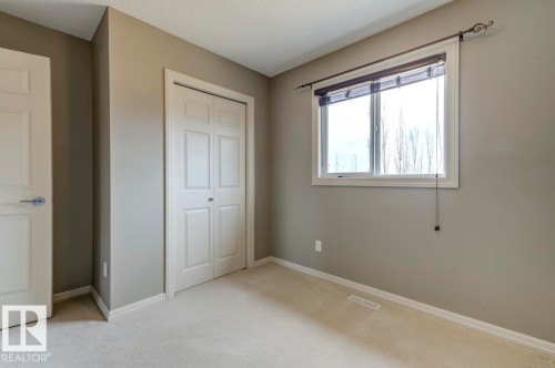 Bright room featuring light gray walls and plush carpeting - 119 Rue Monique, Beaumont, AB - Indoor Photo Showing Other Room