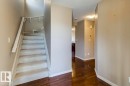 Staircase featuring carpeted treads and a painted handrail - 119 Rue Monique, Beaumont, AB  - Indoor Photo Showing Other Room 