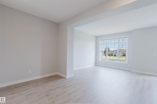 Expansive window framing a neighborhood landscape - 3 11373 12 Avenue, Edmonton, AB - Indoor