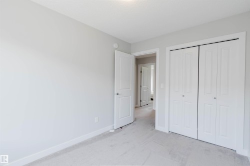 Neutral wall colors, white trim, and light gray carpet - 3 11373 12 Avenue, Edmonton, AB - Indoor