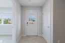 Entryway featuring a white paneled door with glass inserts, smart lock hardware, and light-toned tile flooring - 3 11373 12 Avenue, Edmonton, AB  - Indoor Photo Showing Other Room 