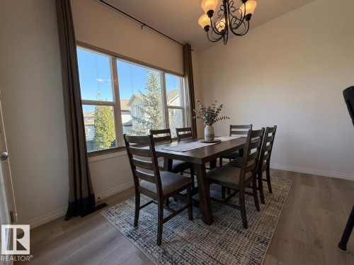 Light wood-finish flooring extending throughout the open concept living area - 2335 Rutherford Way, Edmonton, AB - Indoor Photo Showing Living Room