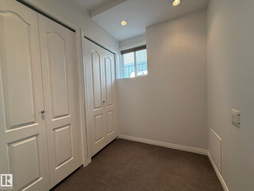Twin bi-fold closet doors to the Furnace Room and this is an Extra LAUNDRY ROOM HOOKUPS! - 2335 Rutherford Way, Edmonton, AB - Indoor Photo Showing Other Room