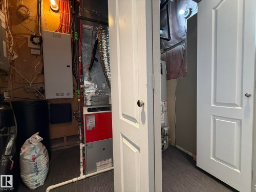 Utility room featuring a furnace, water heater, and electrical panel - 2335 Rutherford Way, Edmonton, AB - Indoor Photo Showing Other Room