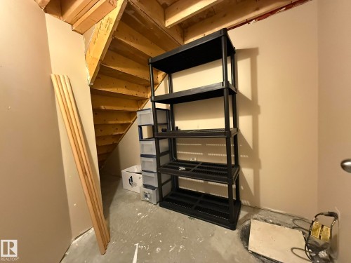 HERE IS MORE STORAGE SPACE UNDER THE BASEMENT STAIRS! THIS IS WHERE THE SUMP PUMP & BACKFLOW VALUE IS CLEARING LOCATED IN MY HOUSE! :) - 2335 Rutherford Way, Edmonton, AB - Indoor Photo Showing Other Room