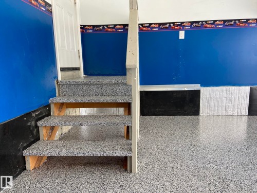 EVEN THE STAIRS HAVE THE EPOXY COATING ON THEM FOR THE GREATEST OF DURABILITY! - 2335 Rutherford Way, Edmonton, AB -  Photo Showing Other Room