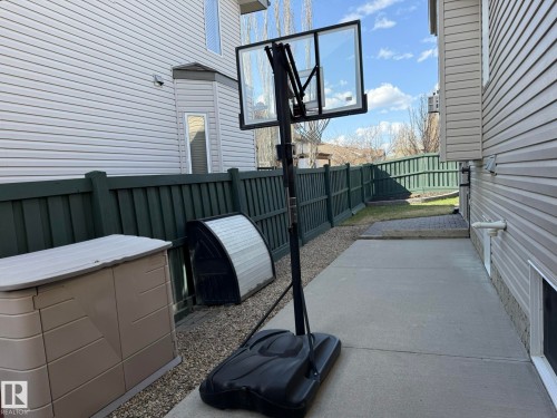 HERE IS THE OTHER SIDE OF THE DRIVE-THRU CONCRETE PAD FOR ALL YOUR TOYS TO BE STORED OUT OF SITE & MIND!....PLUS THE BASKETBALL NET IS ALSO INCLUDED!! - 2335 Rutherford Way, Edmonton, AB - Outdoor With Exterior