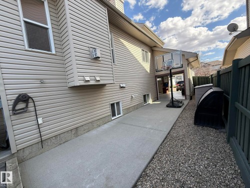 HERE IS THE LONG 20Ft CONCRETE PAD BEHIND THE DRIVE-THRU SINGLE PART OF THE TRIPLE GARAGE! - 2335 Rutherford Way, Edmonton, AB - Outdoor With Exterior