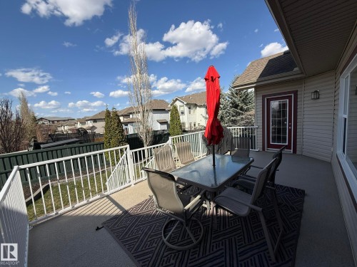 Exterior deck featuring durable siding, a framed glass-paneled door, and a white railing system & THE PATIO FUTURE IS ALL INCLUDED!! - 2335 Rutherford Way, Edmonton, AB - Outdoor With Deck Patio Veranda With Exterior