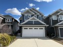 Contemporary two-story residence featuring a two-car garage with white paneled doors and window accents - 16627 18 Avenue, Edmonton, AB  - Outdoor With Facade 