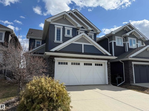 Two-story residence featuring a blue siding exterior with white trim accents - 16627 18 Avenue, Edmonton, AB - Outdoor