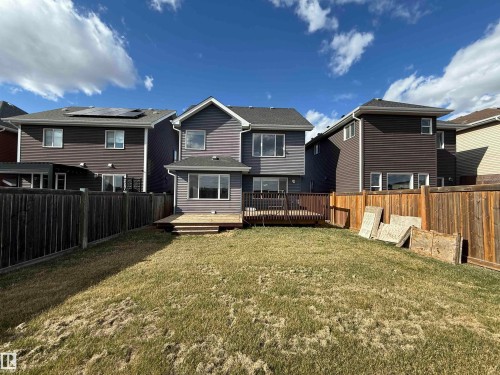 Expansive backyard featuring a partial wood fence, a multi-level wood deck, and a grass lawn - 16627 18 Avenue, Edmonton, AB - Outdoor