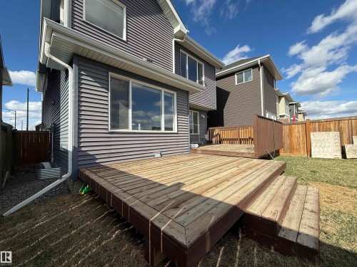 Multi-level wood deck with steps, wood plank siding, and white window frames - 16627 18 Avenue, Edmonton, AB - Outdoor With Deck Patio Veranda With Exterior