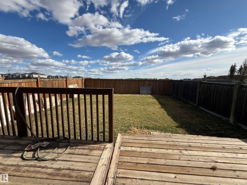 Wood-finish deck with railing overlooking a fenced backyard - 16627 18 Avenue, Edmonton, AB - Outdoor With View