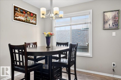 Dining area featuring wood-finish flooring and neutral wall tones - 18080 89 Street, Edmonton, AB - Indoor Photo Showing Dining Room