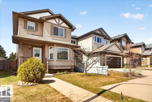 Two-story residence featuring light brown horizontal siding with decorative white trim accents - 18080 89 Street, Edmonton, AB - Outdoor With Facade