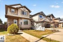 Two-story residence featuring light brown horizontal siding with decorative white trim accents - 18080 89 Street, Edmonton, AB  - Outdoor With Facade 