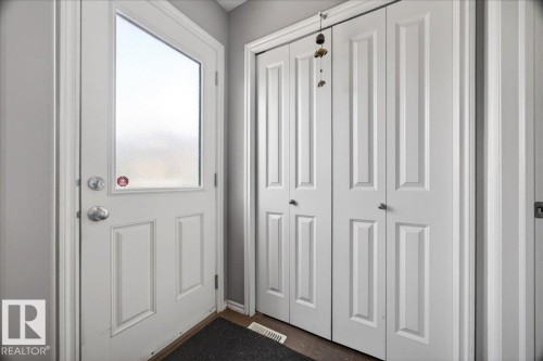 Entryway featuring a white paneled door with a frosted glass insert and satin nickel hardware - 18080 89 Street, Edmonton, AB - Indoor Photo Showing Other Room